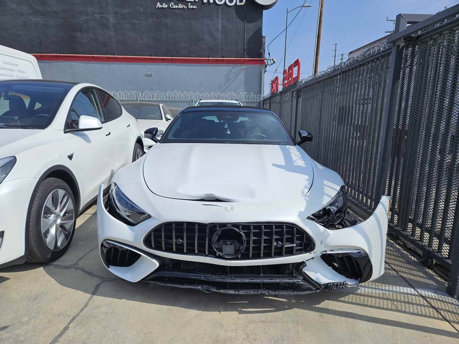 White Mercedes-AMG SL with front-end damage