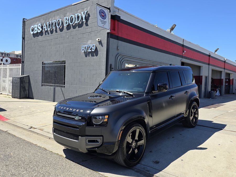 Matte black Land Rover Defender outside CBS Auto Body