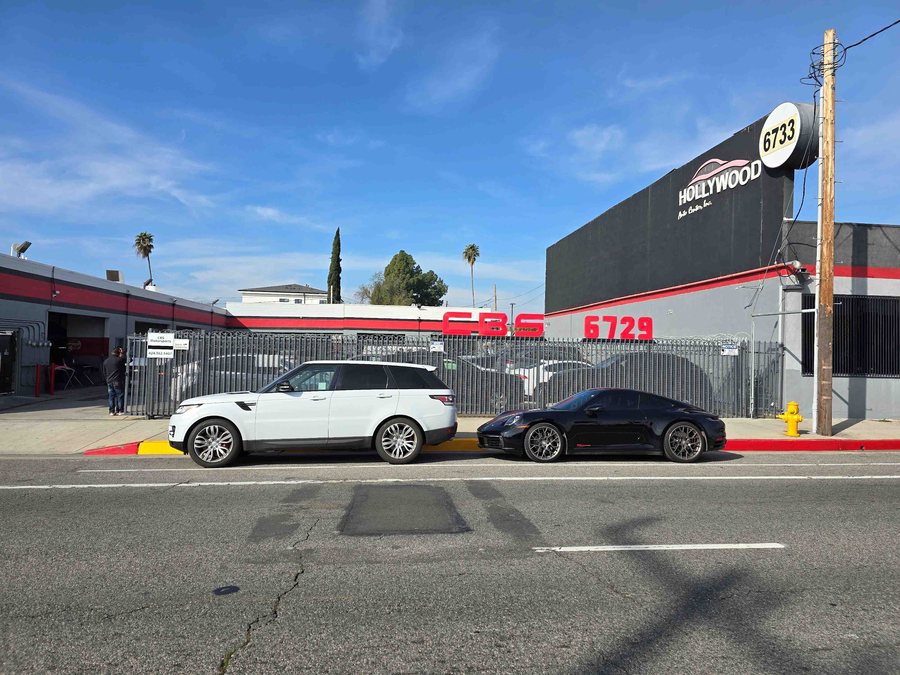 Range Rover and Porsche parked outside CBS Auto Body on Lankershim Boulevard